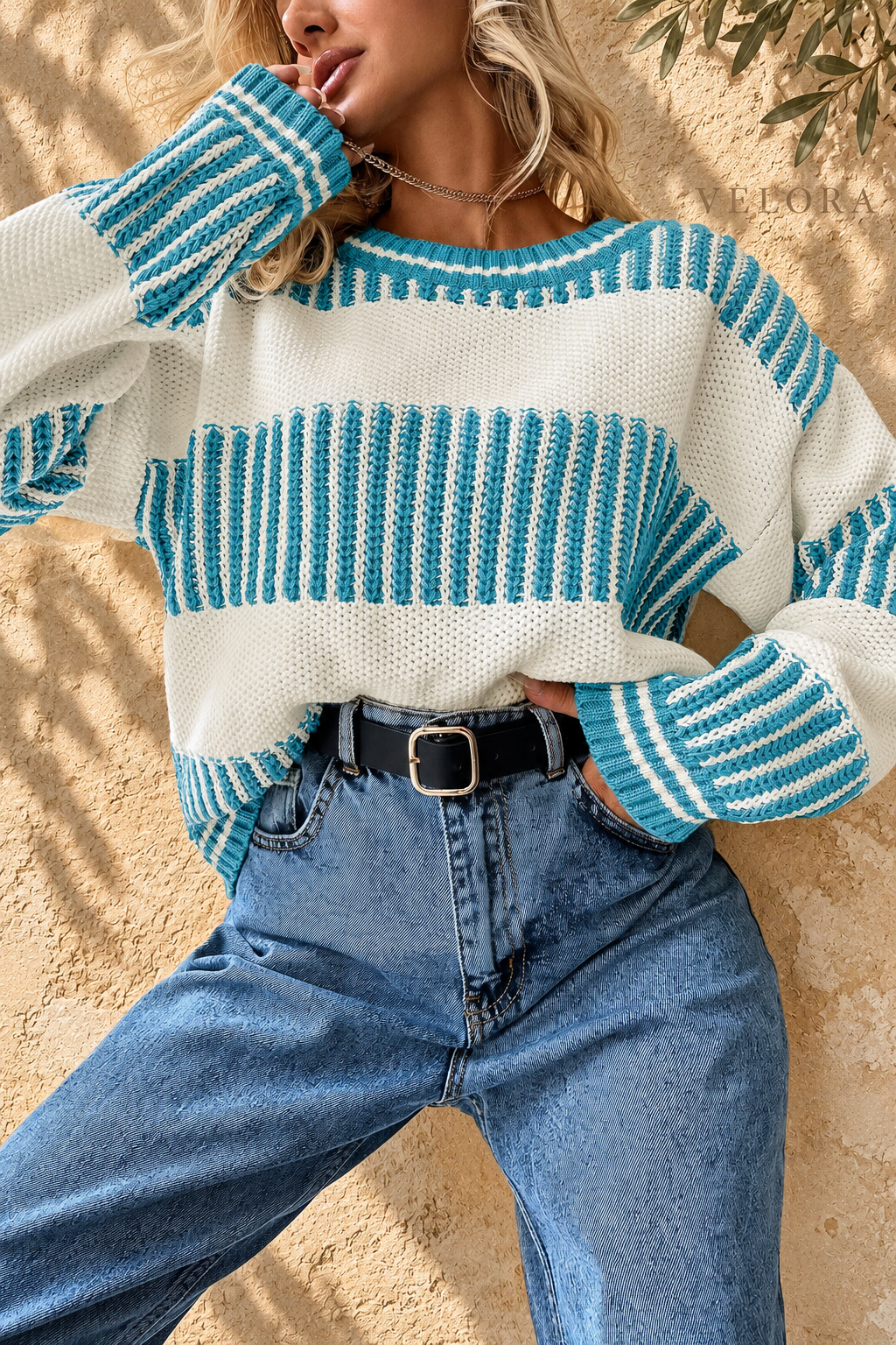 Two-Tone Striped Drop Shoulder Sweater turquoise and cream front view, VELORA Mediterranean setting