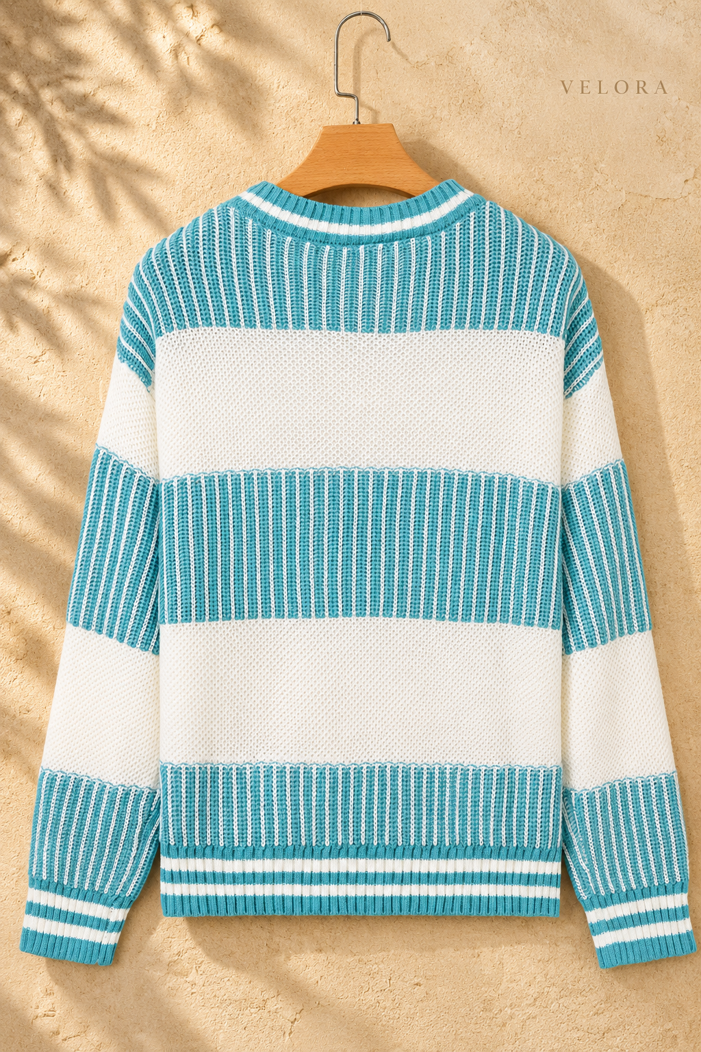 Two-Tone Striped Drop Shoulder Sweater turquoise and cream hanger back view, VELORA Mediterranean setting