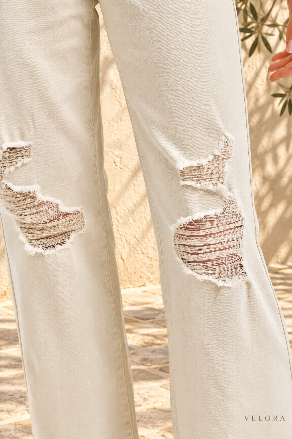VELORA cream distressed wide-leg jeans view 4 Mediterranean background