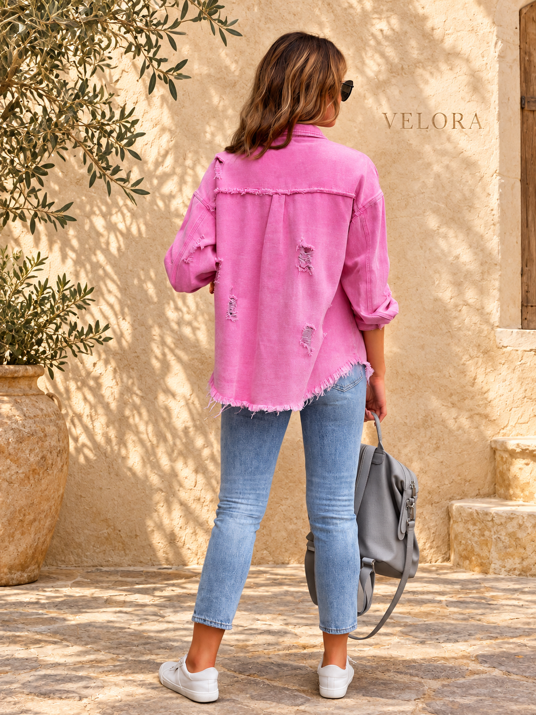 VELORA denim jacket variation 2 on warm Mediterranean plaster