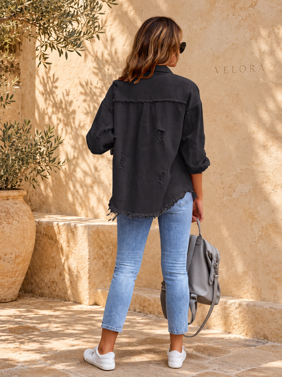 VELORA denim jacket variation 12 on warm Mediterranean plaster