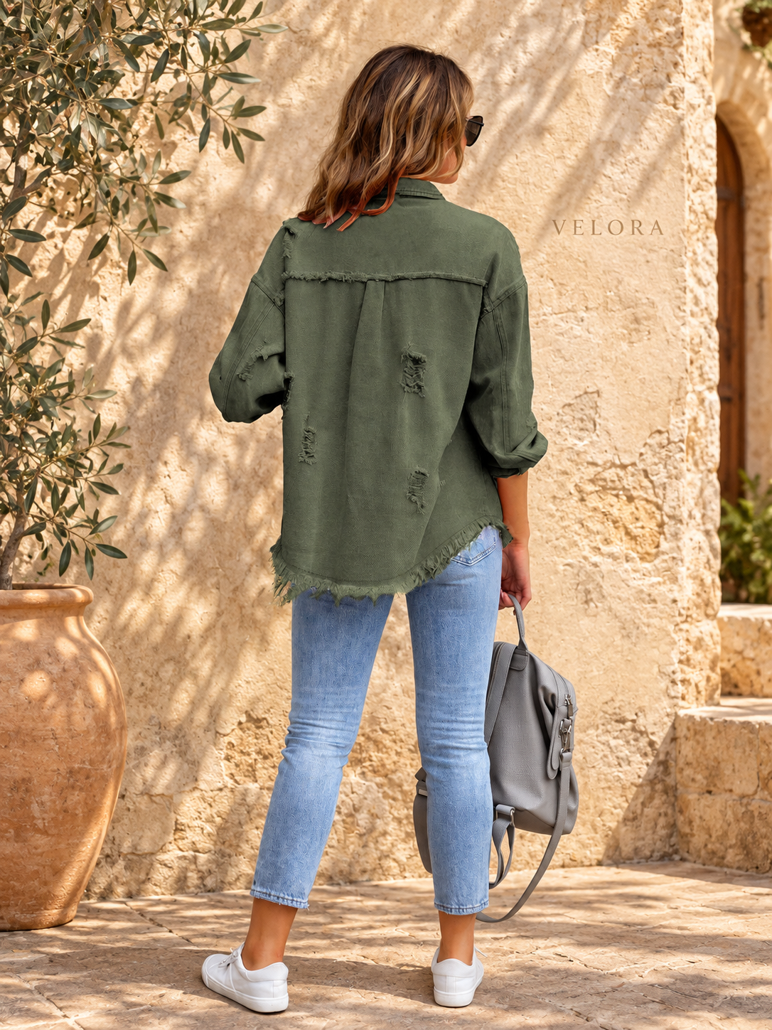 VELORA denim jacket variation 32 on warm Mediterranean plaster