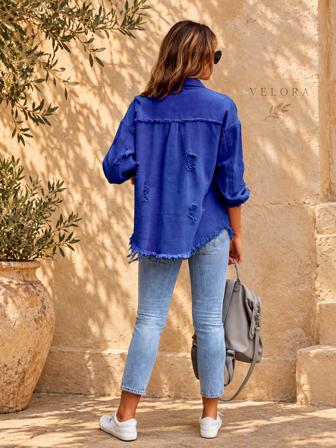 VELORA denim jacket variation 9 on warm Mediterranean plaster