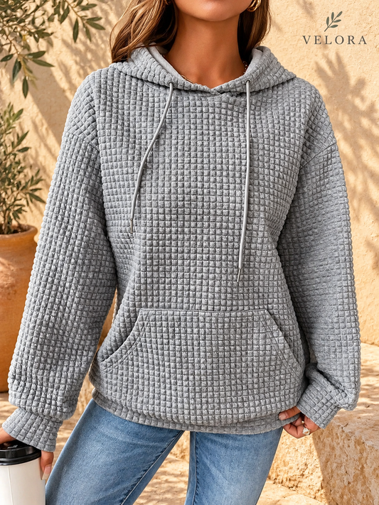 VELORA textured hoodie look 1 on warm Mediterranean plaster