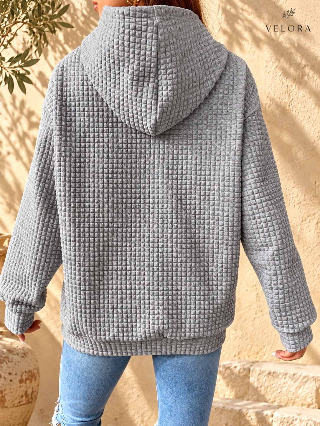 VELORA textured hoodie look 3 on warm Mediterranean plaster